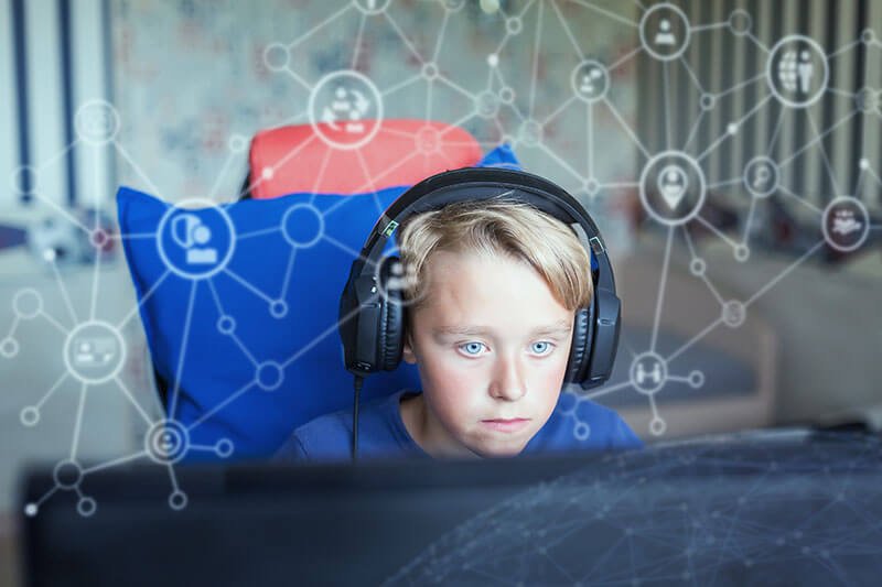 Child alone on computer with connection graphics